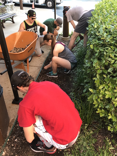 “Hands and Feet” participants work on a landscaping project as part of their week of service and learning in St. Louis.