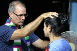  Ary Fernandez baptizes a new member of the Presbyterian Mission at Manati.