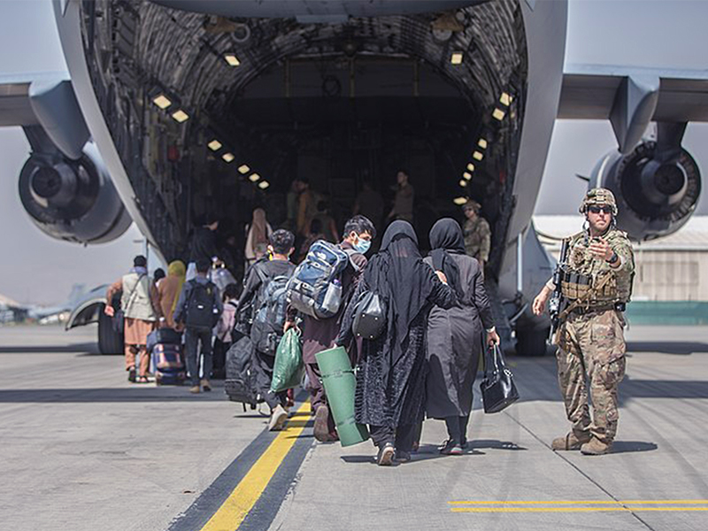 Families begin to board a U.S. Air Force Boeing C-17 Globemaster III during an evacuation at Hamid Karzai International Airport, Kabul, Afghanistan, Aug. 23. U.S. service members are assisting the Department of State with an orderly drawdown of designated personnel in Afghanistan. (U.S. Marine Corps photo by Sgt. Samuel Ruiz).
