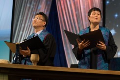 Worship leaders address plenary during closing worship