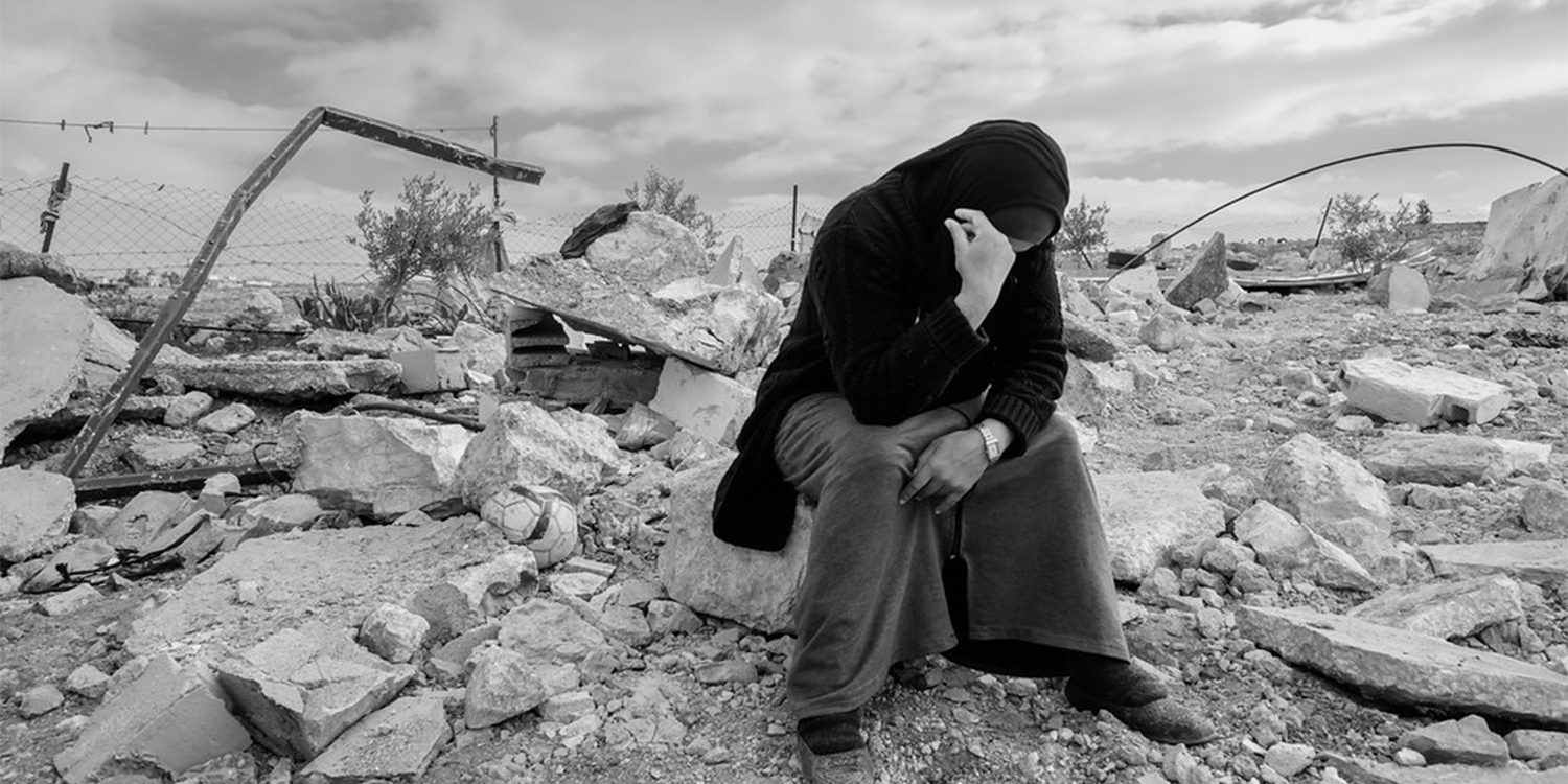 Woman sitting on the ruins of her house' destroyed by Israel in Masafer Yatta January 2023